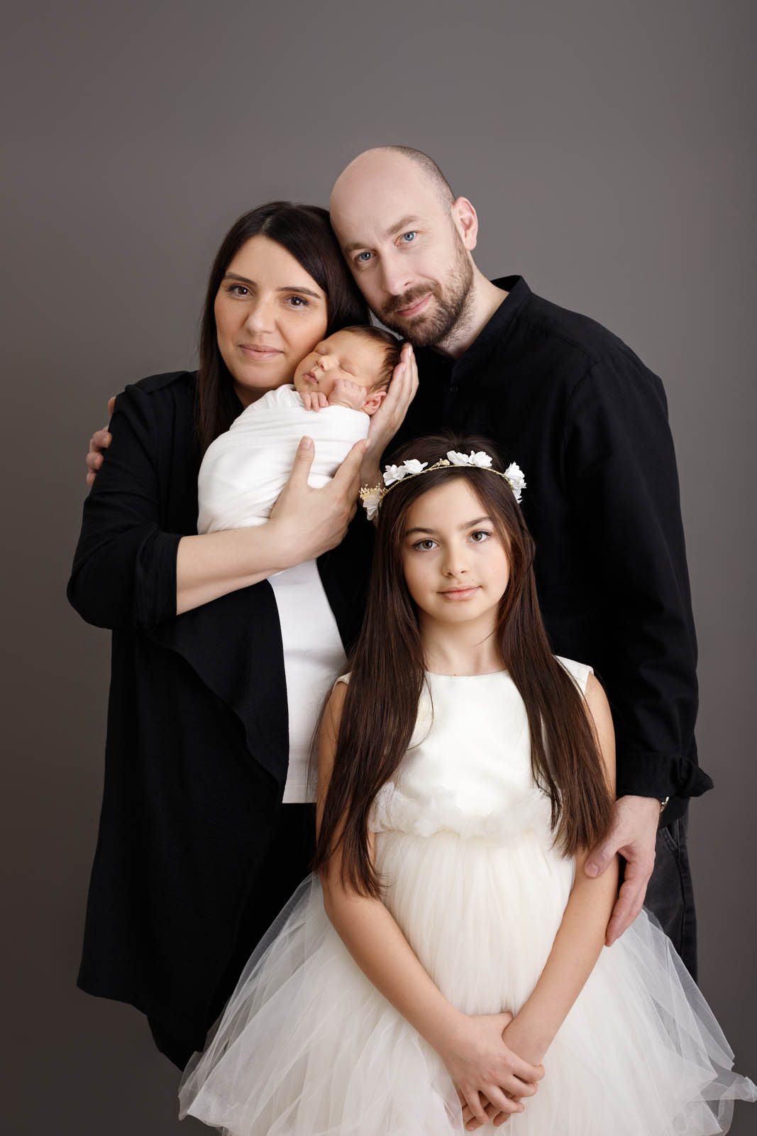 Family of four with their newborn on a grey backdrop — Studio Muffin Tbilisi