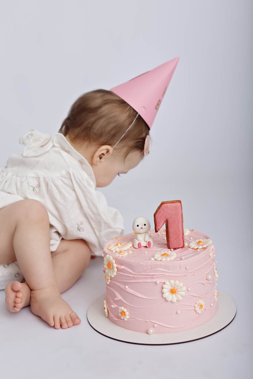 Baby girl with birthday balloons and bunny — first birthday session Tbilisi