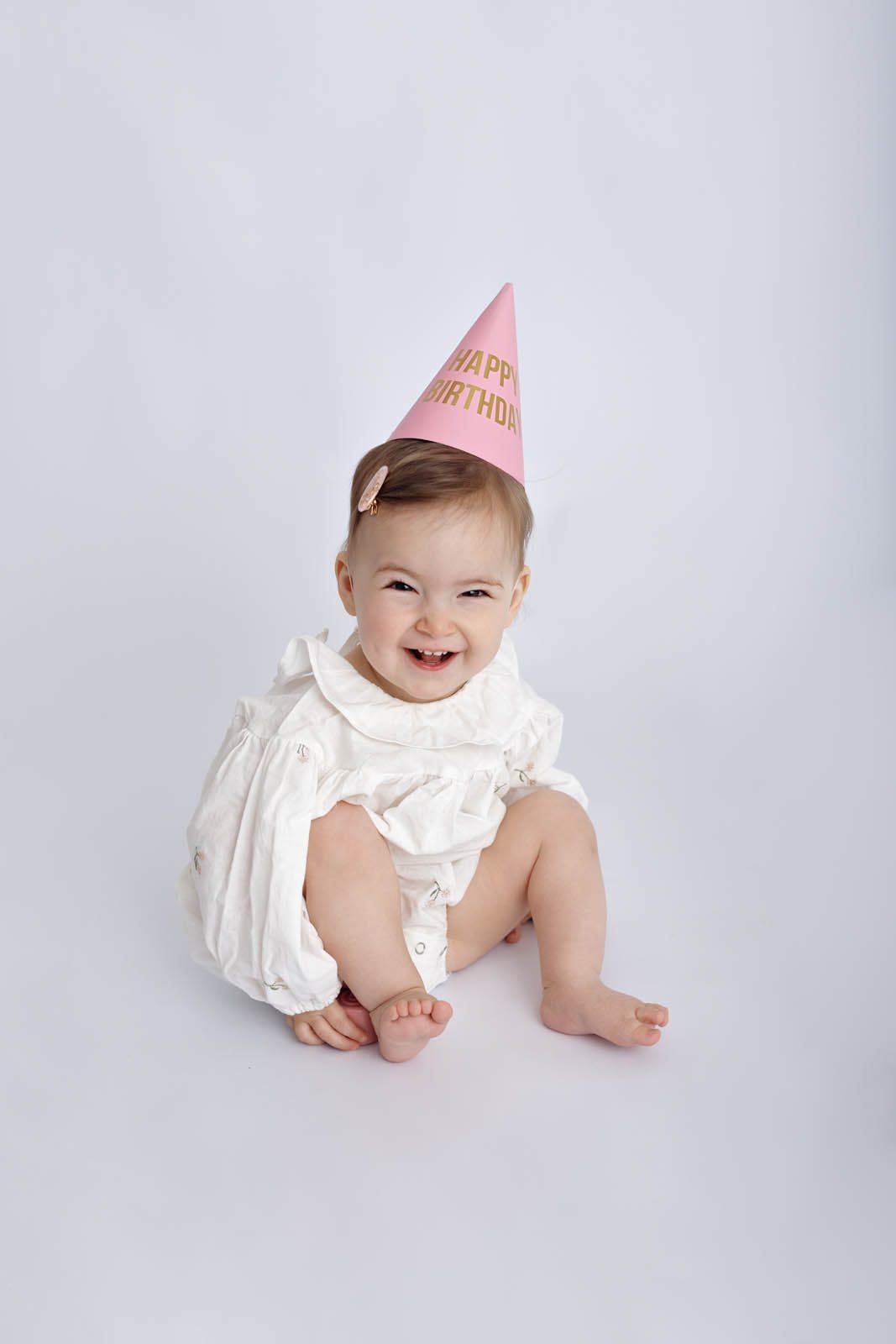 Happy birthday girl in a party hat — first birthday session, Studio Muffin Tbilisi