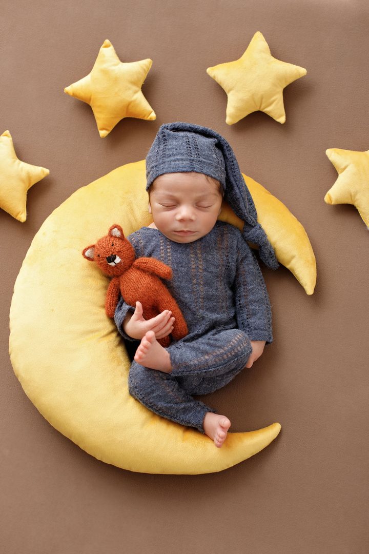 Newborn baby curled in a delicate wrap — newborn photographer in Tbilisi