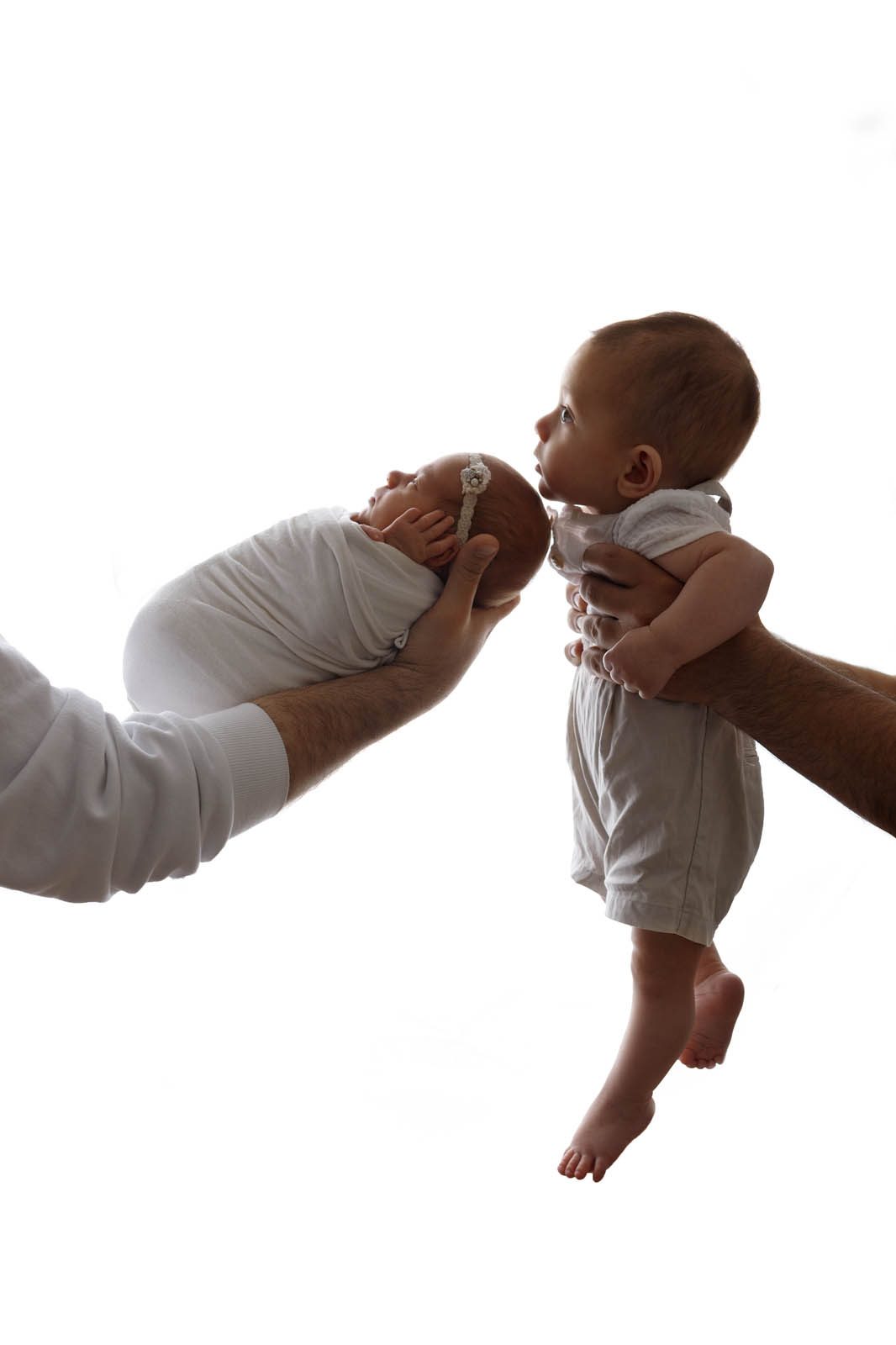 Toddler and newborn face to face — sibling newborn photography in Tbilisi